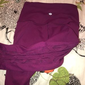 Lululemon pink pants with mesh side panels.